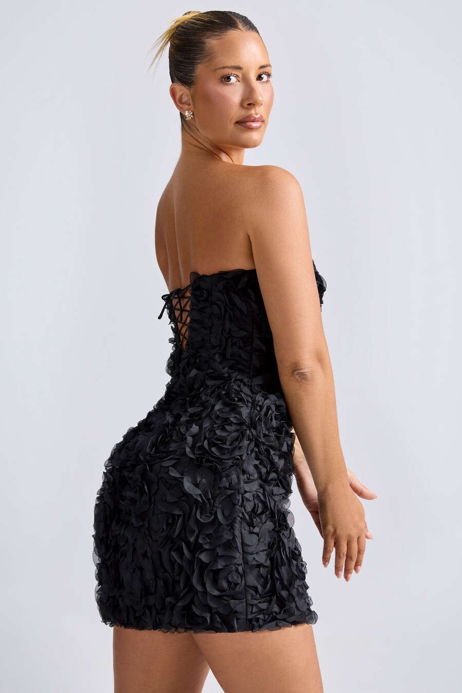 vestido curto evasê tomara que caia com apliques florais na cor preta.