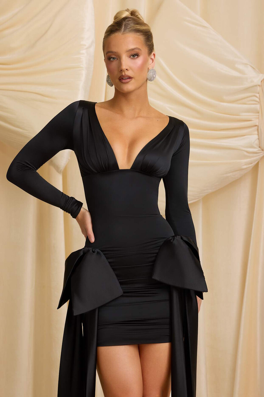 vestido curto preto com detalhe de laço e drapeado.