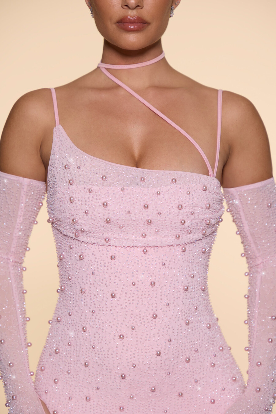 vestido curto assimétrico com corpete bordado na cor rosa claro.