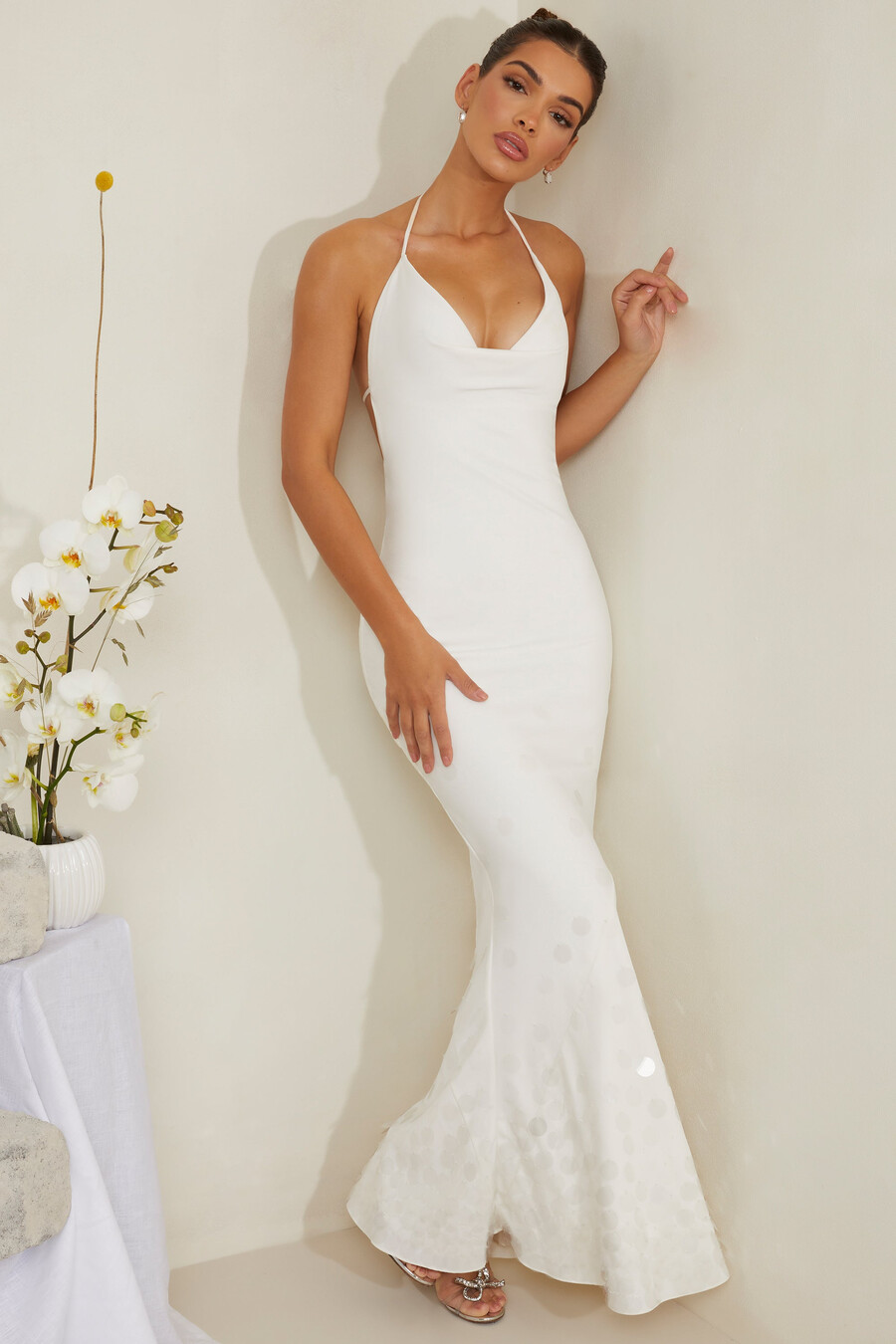 vestido longo de cetim branco com decote drapeado e aplicações.