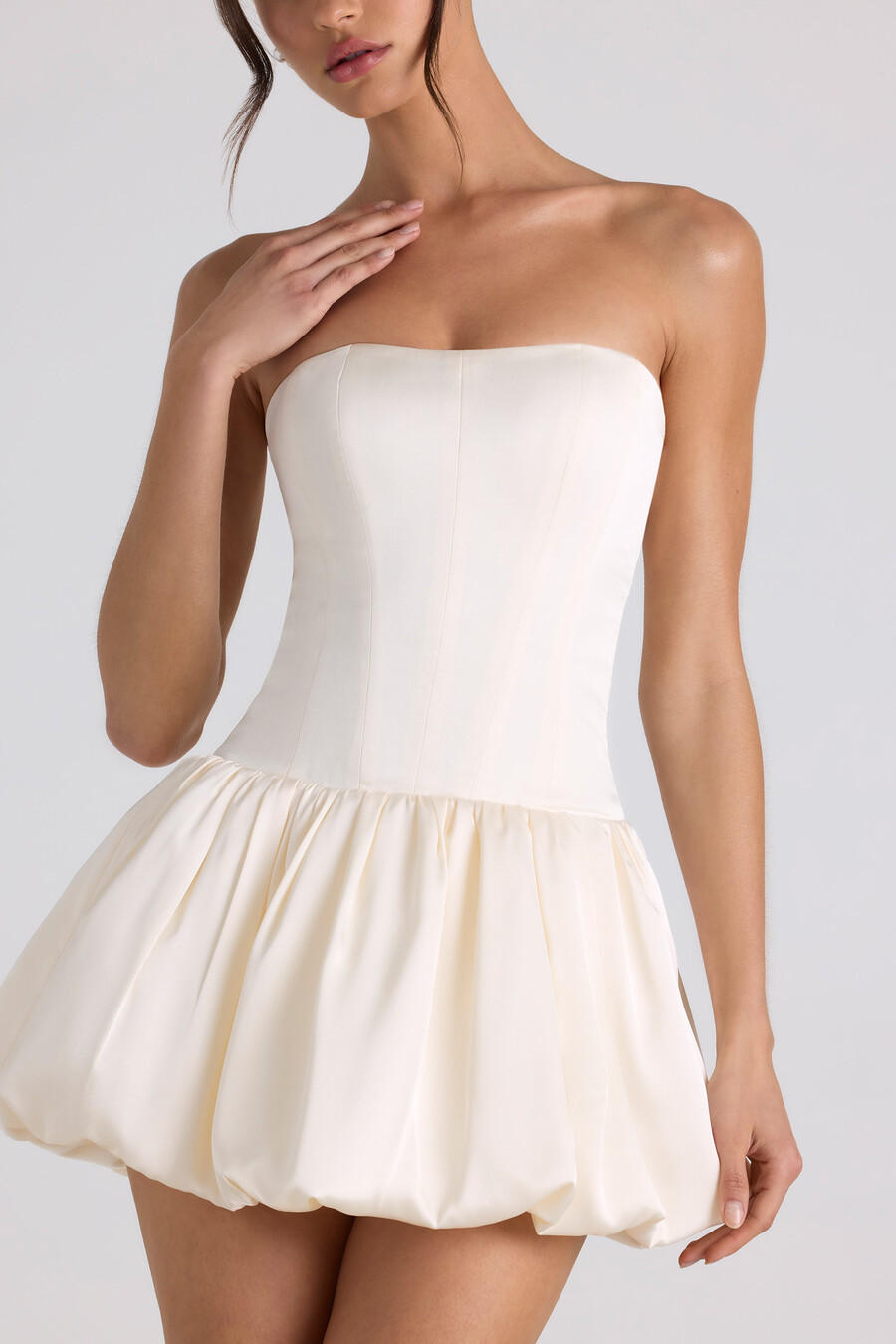 vestido curto estilo corset com barra balonê e amarração nas costas na cor marfim.